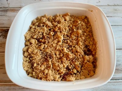 Adding streusel topping before baking in the oven Adding streusel topping before baking in the oven