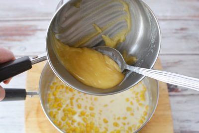 Adding butter mixture to creamed corn Adding butter mixture to creamed corn